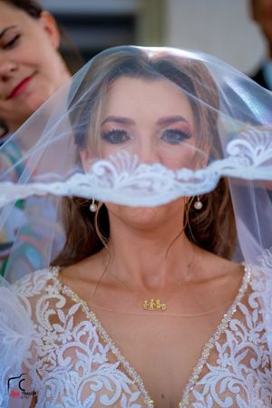 Close-up shot of a bride's wedding day look featuring lace details and jewelry.