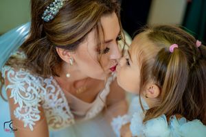 Tender moment captured between wedding attendants during pre-ceremony preparations.