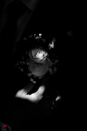 Artistic black and white floral arrangement detail at an elegant wedding ceremony.