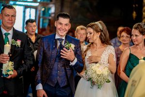 Wedding celebration scene with guests in formal attire.