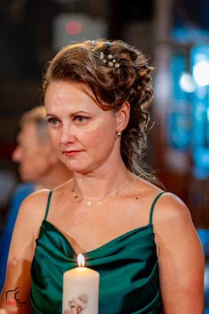 Person in emerald green formal attire at an elegant evening event.