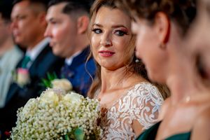 Wedding party members gather for formal celebration with decorative floral arrangements.