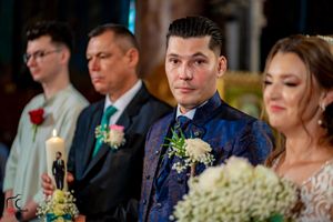 Wedding party members pose during reception with elegant decor and mood lighting.