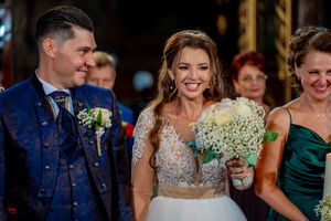 Joyful wedding moment captured in ornate church interior with elegant lighting.