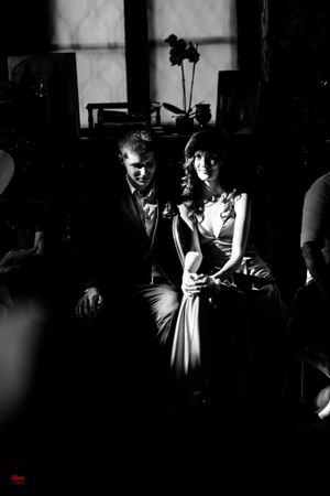Dramatic black and white portrait of couple in formal attire.