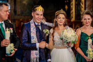 Wedding couple and attendants pose with bouquets during formal celebration.