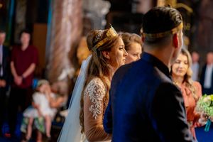 Orthodox wedding ceremony with guests gathered in a traditional church setting.