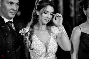 Wedding party members share intimate moments during an evening celebration.