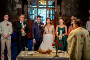 Elegant wedding reception venue with ornate chandeliers and blue uplighting creating a romantic atmosphere.
