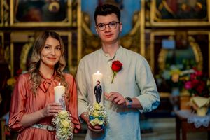 Couple holding candles during an intimate wedding ceremony moment.