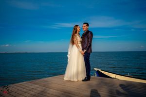 Bride and groom share tender moments during their seaside wedding photography session.