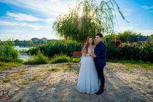 Scenic outdoor wedding location with water views and natural landscaping in panoramic format.