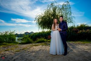 Outdoor wedding venue with natural landscaping and mountain backdrop in panoramic format.