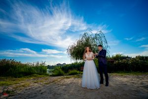 Sweeping landscape view of an outdoor wedding venue with dramatic clouds and greenery.