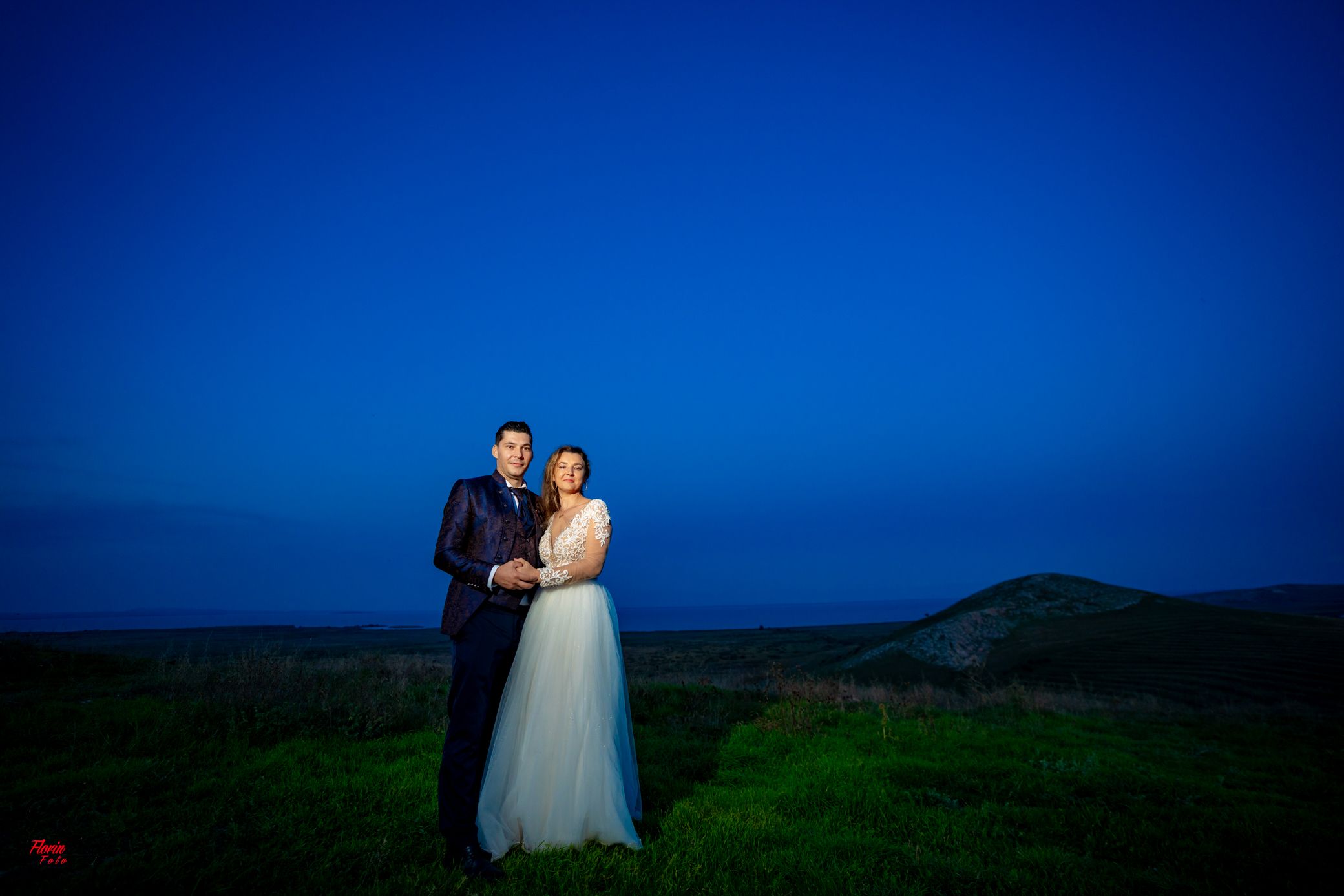 Wedding photography session in scenic countryside location during blue hour.