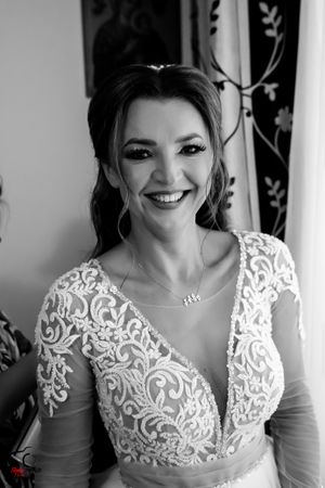 Black and white bridal portrait showcasing delicate lace details on a V-neck wedding gown.