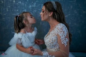 An emotional family portrait showing love and connection against a moody blue backdrop.