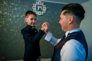 A joyful high-five exchange against a decorative wall background.