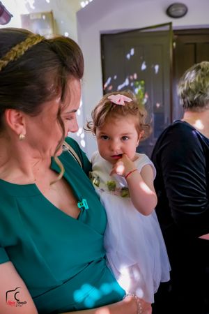 Natural light fills the room during tender moments of wedding preparations.