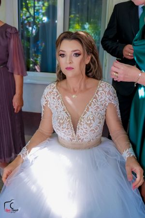Close-up of an ornate wedding dress featuring delicate lace details and a plunging neckline.
