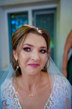 Bride wearing delicate lace gown and veil showing joyful expressions in a series of photos.
