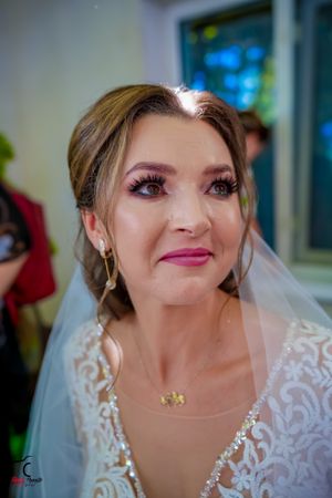 Close-up bridal portrait showing detailed lace neckline and delicate jewelry.