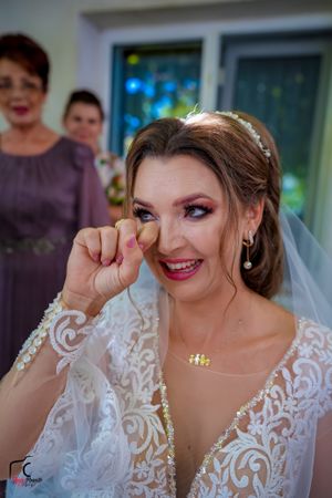 Series of emotional expressions from bride wearing traditional white lace wedding dress.