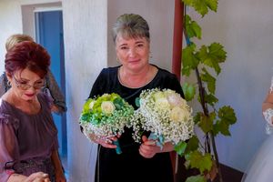 Wedding party members gathered together wearing formal attire in various colors.