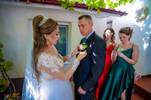 Sun-drenched wedding scene with formal attire and elegant decorations.
