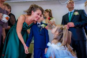 Wedding celebration candid moments captured with guests in formal attire.