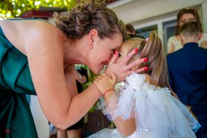Wedding attendees interact during an emotional moment at the reception.