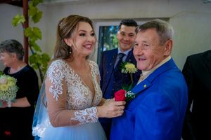 Wedding guests gather for a celebration with someone wearing a vibrant royal blue suit.
