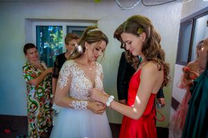 Wedding guests engaged in conversation during an indoor reception celebration.