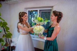Joyful candid moments between wedding party members in formal attire.