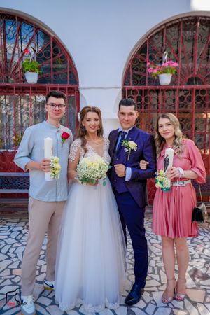 Wedding party poses together in formal attire with white, navy, and pink color scheme.