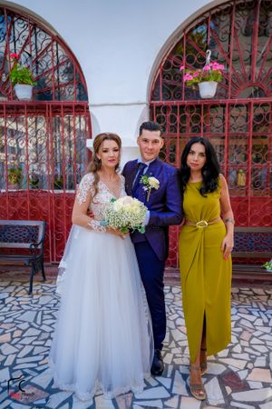 Wedding portraits featuring bride in white gown with guests in navy and yellow attire.