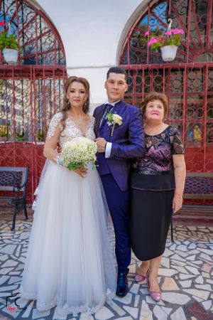 Formal wedding photos showing bride and guests against architectural backdrop with red metalwork.