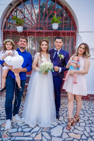 Casual wedding photo series showing various family groupings against decorative archway.