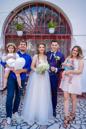 Wedding celebration photos showing various family groupings against decorative red iron gate.