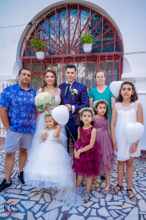 Series of wedding party portraits with children in formal wear against stone and iron backdrop.