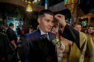 Wedding celebration scene with formal attire and decorative lighting elements.