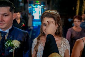 Elegant wedding reception with guests mingling under decorative lighting.