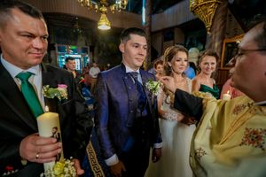 Candid wedding reception scene showing guests interacting in a cozy indoor setting.