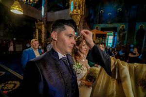 Intimate wedding reception moment captured in warm lighting with guests in formal attire.