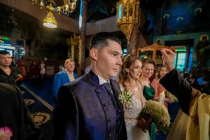 Wedding celebration scene with elegant decor and ambient lighting in an indoor venue.