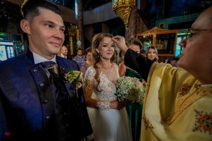 Guests mingling at an elegant indoor wedding reception with ambient lighting.