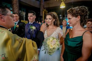 Wedding celebration scene with guests in formal attire and elegant decor.