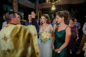 Wedding reception scene showing guests gathered in a warmly lit indoor space.