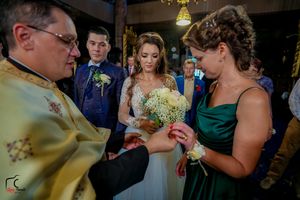 Wedding celebration showing guests gathered at an indoor venue with string lights.