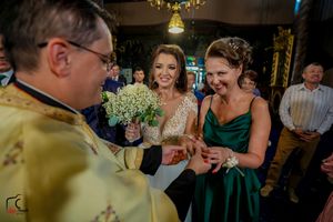 Festive indoor wedding reception with guests mingling under warm lighting.